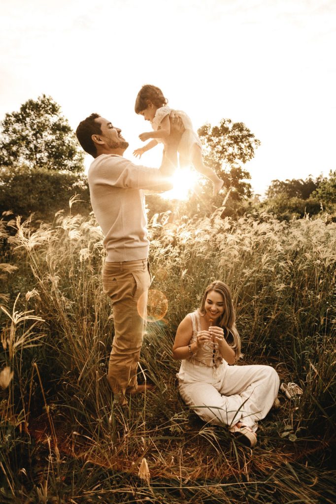 Traveling family playing with their kid.