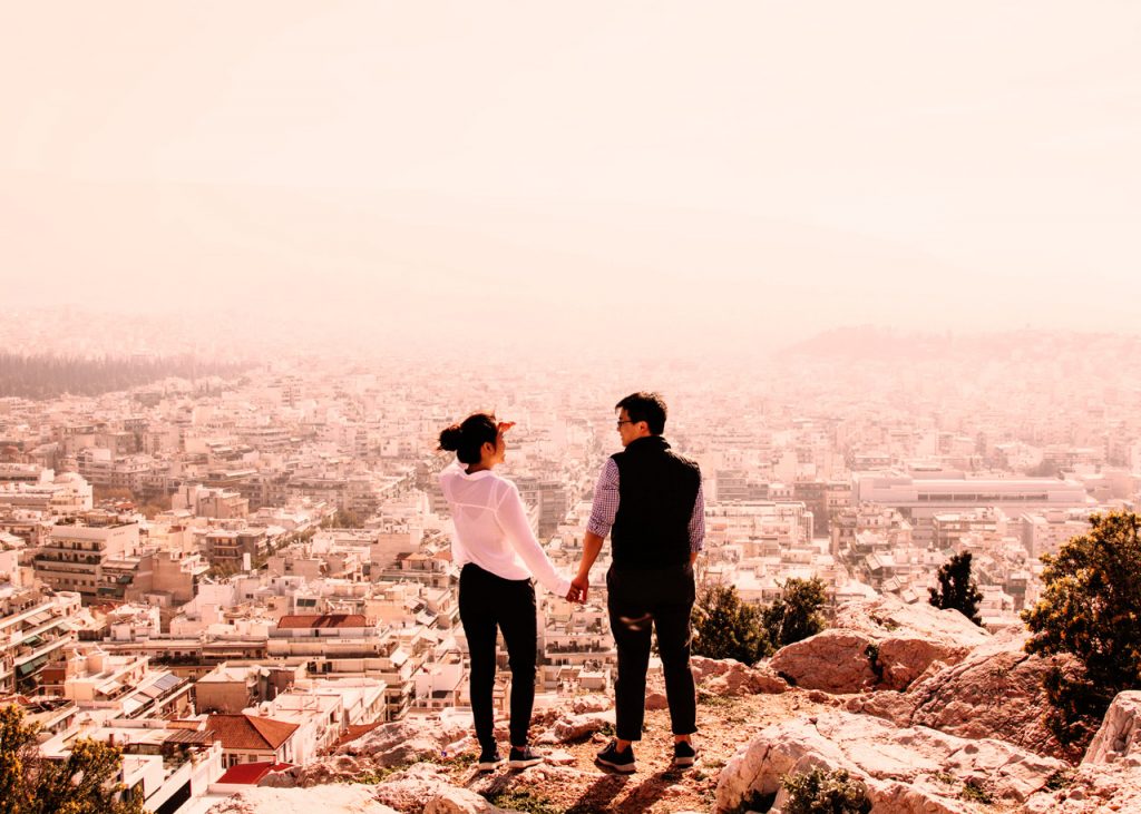 Tourists in Athens enjoying a view of the city.