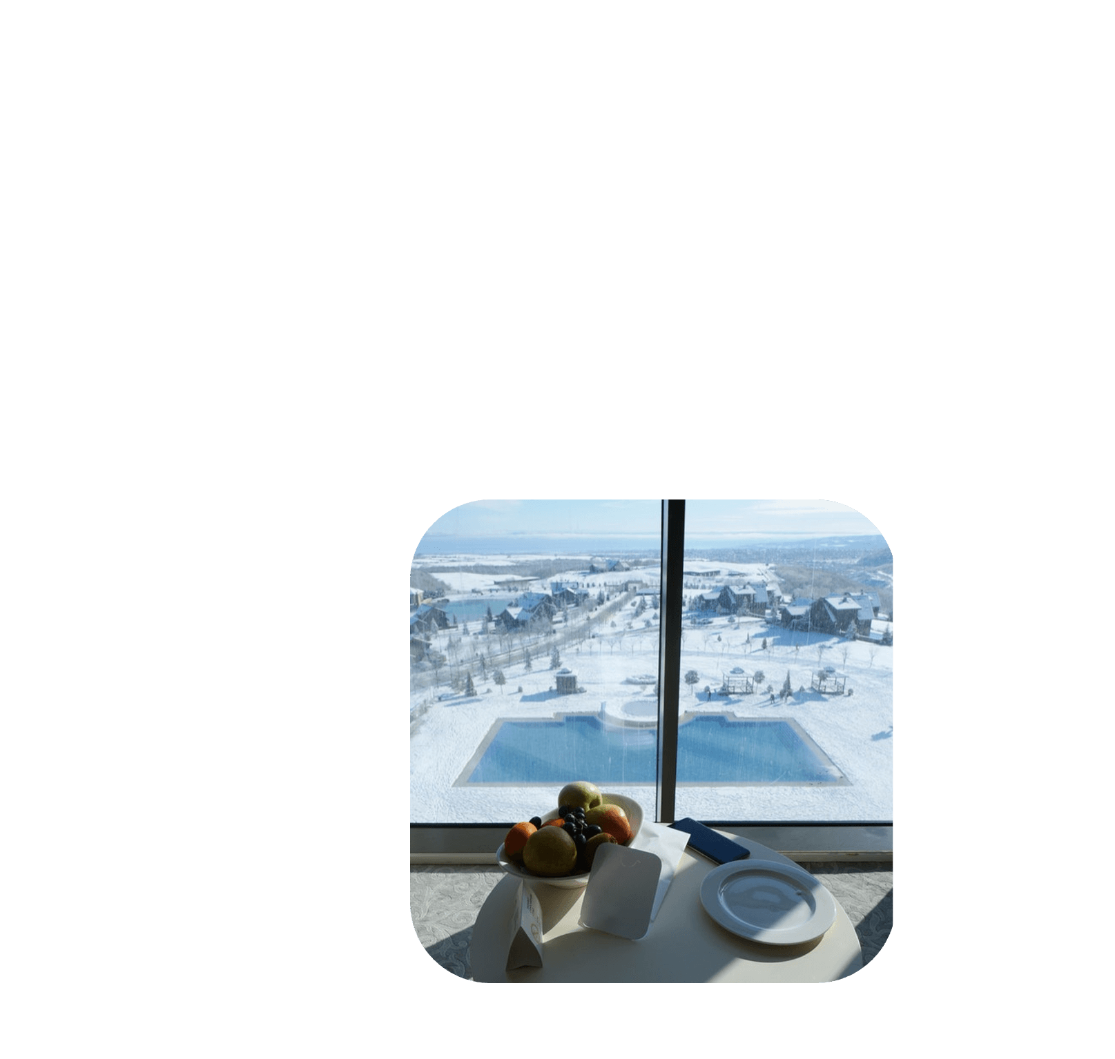 winter hotel resort with window view to snow and pool, representing an excellent guest experience